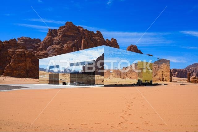 The Maraya mirrored concert hall reflecting the ancient desert mountains of Ashar Valley in AlUla, Saudi Arabia