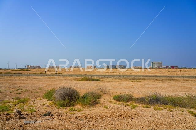 الأفق الناشئ لمدينة الملك عبد الله الاقتصادية (KAEC) كما يُرى من الصحراء المحيطة بها في المملكة العربية السعودية الأفق الناشئ لمدينة الملك عبد الله الاقتصادية (KAEC) كما يُرى من الصحراء المحيطة بها في المملكة العربية السعودية