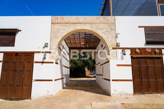 Traditional stone archway and wooden pergola in the historic Al-Balad district of Yanbu, Saudi Arabia