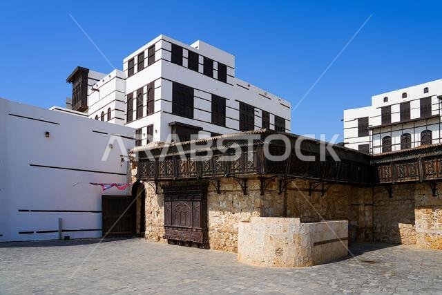 Traditional wooden roshan and mashrabiya on a coral stone wall in Yanbu, Saudi Arabia Traditional wooden roshan and mashrabiya on a coral stone wall in Yanbu, Saudi Arabia