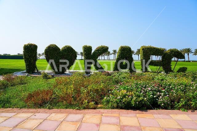 I Love KAEC topiary sign in a lush green park in King Abdullah Economic City, Saudi Arabia