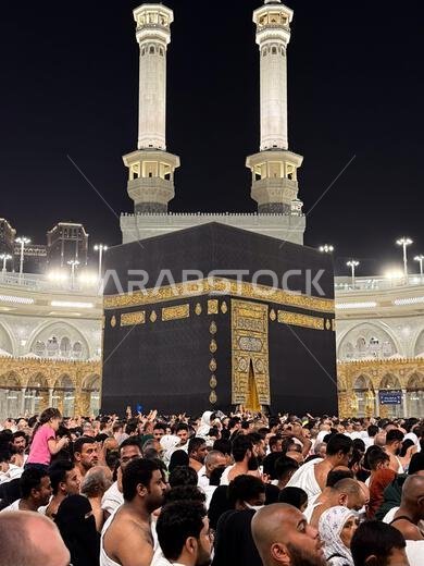 Pilgrims circling the Kaaba at Masjid al-Haram in Mecca during crowded night prayer and Hajj pilgrimage