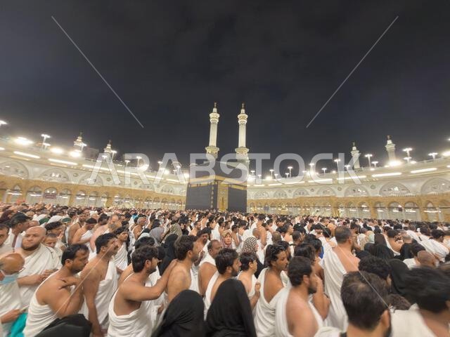 Pilgrims performing tawaf around the Kaaba at Masjid al-Haram in Mecca during crowded night pilgrimage Pilgrims performing tawaf around the Kaaba at Masjid al-Haram in Mecca during crowded night pilgrimage