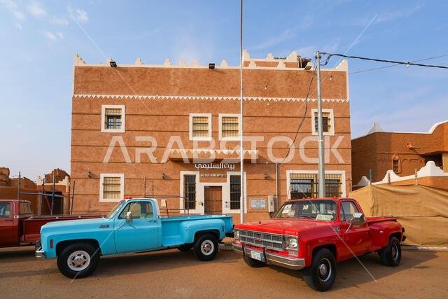 The restored Alsulaimi heritage house and classic trucks in Shaqra village, Saudi Arabia
