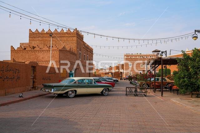 Classic vintage cars parked in the historic mud brick village of Shaqra in Saudi Arabia