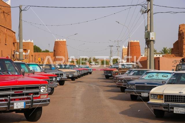 Classic vintage cars parked in the historic mud brick village of Shaqra in Saudi Arabia