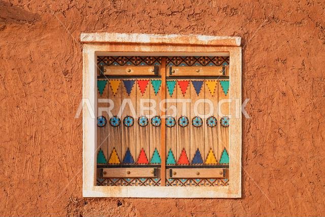 Traditional hand-painted Najdi window with geometric patterns in Shaqra in the heart of Nejd, Saudi Arabia