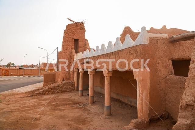 Traditional Najdi mud brick fortification with white crenelations in Shaqra, Saudi Arabia