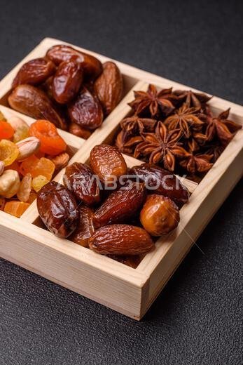 Dried dates on a ceramic plate for Ramadan or Iftar. Dried dates as a food background for your design