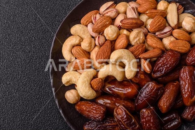Dried dates on a ceramic plate for Ramadan or Iftar. Dried dates as a food background for your design