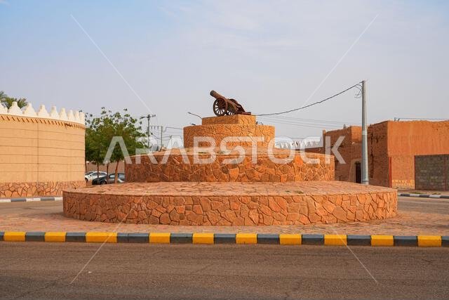 Historical defense cannon monument on a stone pedestal in Shaqra, Saudi Arabia