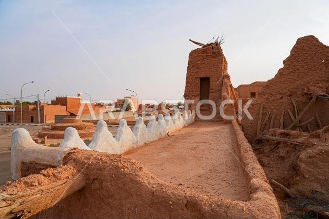 Traditional Najdi mud brick fortification with white crenelations in Shaqra, Saudi Arabia