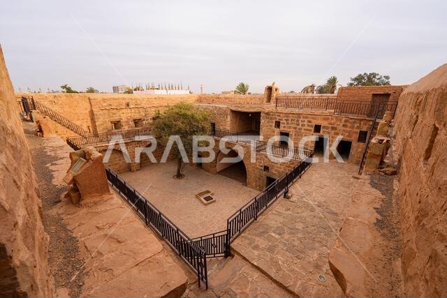 Inner courtyard and multi-level stone architecture of the historic Tabuk Castle, an ancient Ottoman fortress along the Hajj pilgrimage route in Saudi Inner courtyard and multi-level stone architecture of the historic Tabuk Castle, an ancient Ottoman fortress along the Hajj pilgrimage route in Saudi