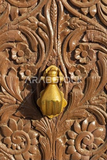 Close-up of a brass knocker on a traditional door in Hijazi-style at the Al Tayebat International City Museum in Jeddah, Saudi Arabia