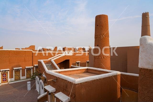 Traditional Najdi mud brick tower with geometric carvings in Shaqra, Saudi Arabia