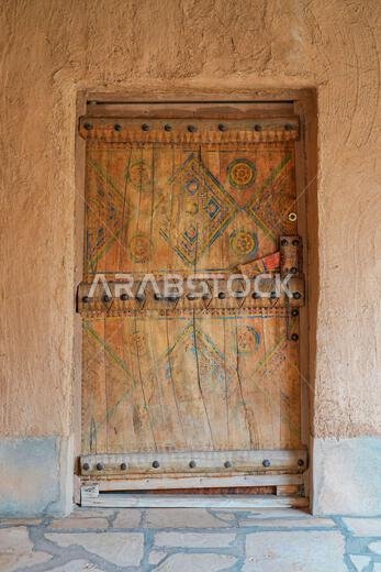 Traditional hand-painted Najdi wooden door in the historic village of Shaqra, Saudi Arabia
