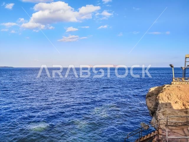 View from the beach in Sharm El Sheikh to Tiran Island in the Red Sea, Egypt. Tropical seascape with desert islets on the horizon