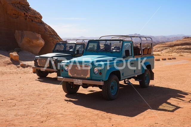 Classic Land Rover Defender safari vehicles for exploring the ancient site of Hegra in Alula, Saudi Arabia