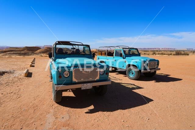 Classic Land Rover Defender safari vehicles for exploring the ancient site of Hegra in Alula, Saudi Arabia