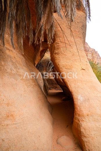 Looking through a natural rock opening in the ancient canyon of Wadi Al Disah near Tabuk in Saudi Arabia