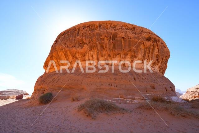 Towering sandstone rock formations at the entrance of Jabal Ithlib in Hegra, AlUla, Saudi Arabia