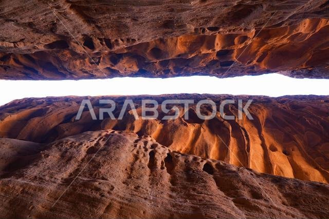 The spectacular entrance of the Siq, a natural canyon passage between sandstone cliffs at the ancient Nabataean sanctuary of Jabal Ithlib in Hegra, Al