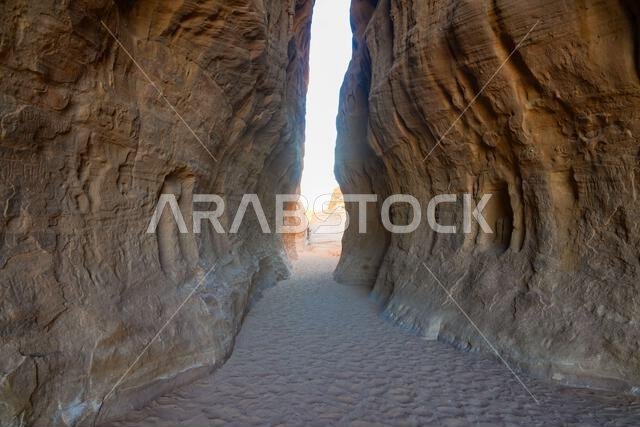 The spectacular entrance of the Siq, a natural canyon passage between sandstone cliffs at the ancient Nabataean sanctuary of Jabal Ithlib in Hegra, Al