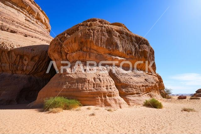 Towering sandstone rock formations at the entrance of Jabal Ithlib in Hegra, AlUla, Saudi Arabia