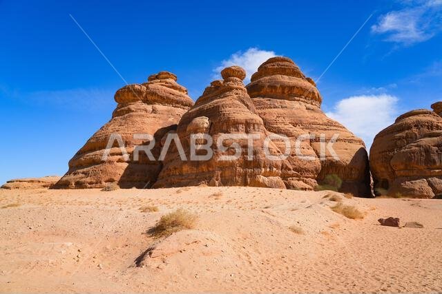 Towering sandstone rock formations at the entrance of Jabal Ithlib in Hegra, AlUla, Saudi Arabia