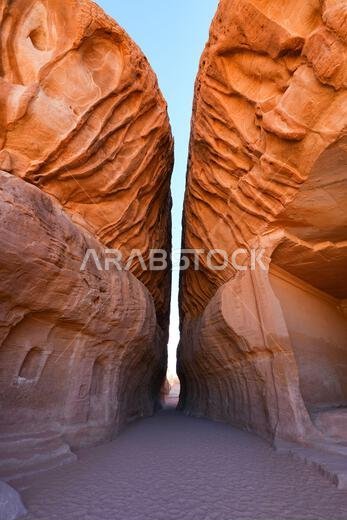 The spectacular entrance of the Siq, a natural canyon passage between sandstone cliffs at the ancient Nabataean sanctuary of Jabal Ithlib in Hegra, Al