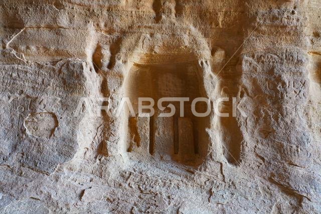 Ancient Nabataean votive niche and baetyls carved into the rock at Jabal Ithlib in Hegra, AlUla, Saudi Arabia