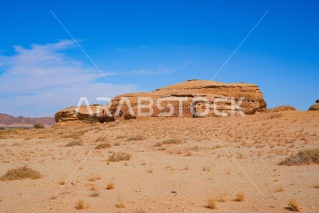 Towering sandstone rock formations at the entrance of Jabal Ithlib in Hegra, AlUla, Saudi Arabia