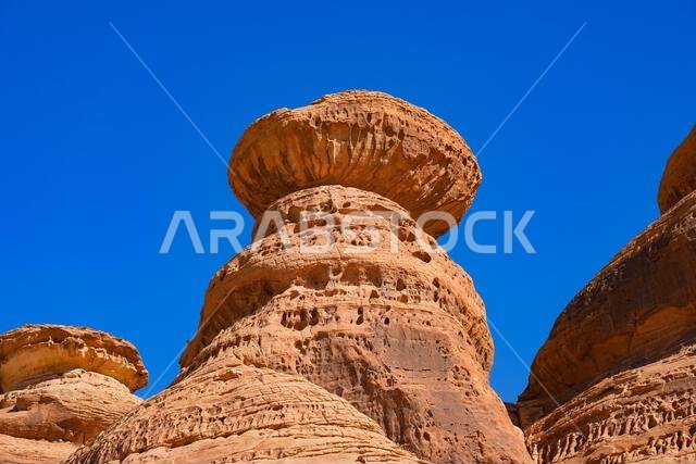 Towering sandstone rock formations at the entrance of Jabal Ithlib in Hegra, AlUla, Saudi Arabia