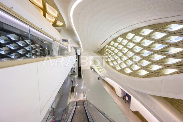 King Abdullah Financial District metro station interior with futuristic undulating sinuous lines, geometric patterns and escalator