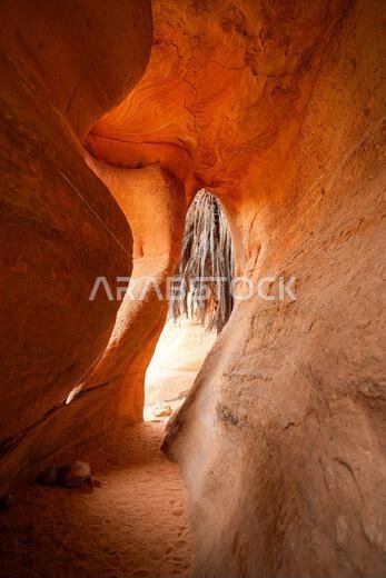Looking through a natural rock opening in the ancient canyon of Wadi Al Disah near Tabuk in Saudi Arabia