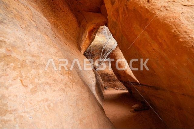 Looking through a natural rock opening in the ancient canyon of Wadi Al Disah near Tabuk in Saudi Arabia