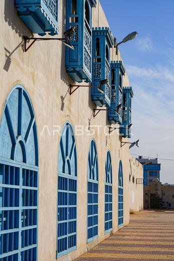 Traditional blue mashrabiya windows at the restored Amerah Souq in Umluj, Saudi Arabia Traditional blue mashrabiya windows at the restored Amerah Souq in Umluj, Saudi Arabia