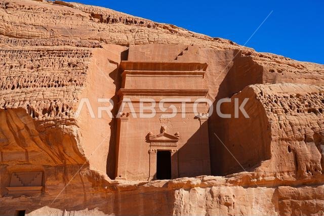 Well-preserved Nabataean tomb facade with ancient inscription at Jabal AlBanat in Hegra, AlUla, Saudi Arabia