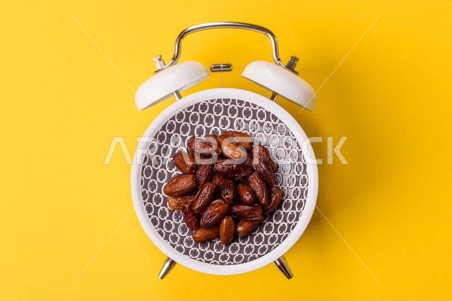 Dried dates on a ceramic plate for Ramadan or Iftar. Dried dates as a food background for your design