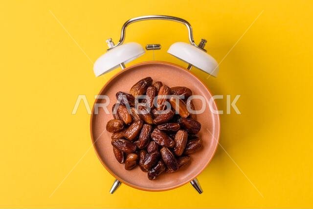 Dried dates on a ceramic plate for Ramadan or Iftar. Dried dates as a food background for your design