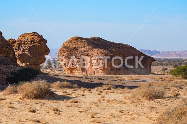 The majestic Jabal AlAhmar monolithic tombs at sunset in Hegra, AlUla, Saudi Arabia