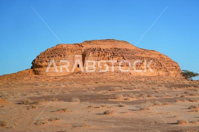 Solitary Nabataean tomb carved into a massive sandstone monolith in Hegra, AlUla, Saudi Arabia Solitary Nabataean tomb carved into a massive sandstone monolith in Hegra, AlUla, Saudi Arabia