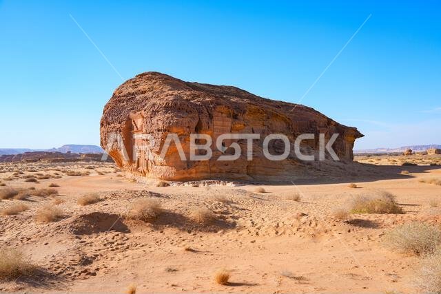 The majestic Jabal AlAhmar monolithic tombs at sunset in Hegra, AlUla, Saudi Arabia The majestic Jabal AlAhmar monolithic tombs at sunset in Hegra, AlUla, Saudi Arabia