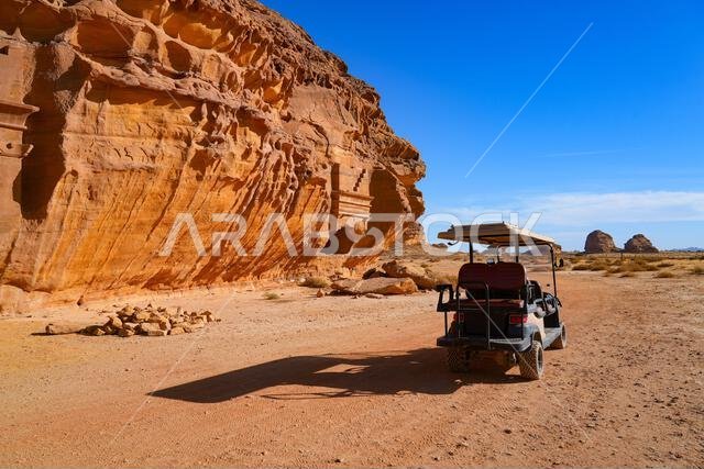 Tourists exploring the ancient site of Hegra in an electric vehicle, AlUla, Saudi Arabia Tourists exploring the ancient site of Hegra in an electric vehicle, AlUla, Saudi Arabia