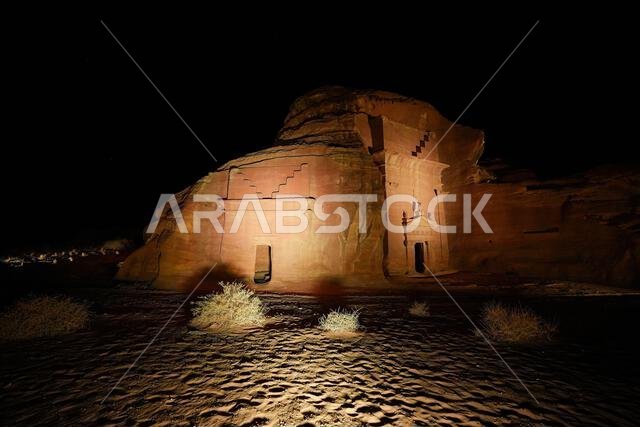 Hegra After Dark experience at the Jabal Al-Khuraymat site of Hegra - Nabataean tombs illuminated by lanterns in AlUla, Saudi Arabia