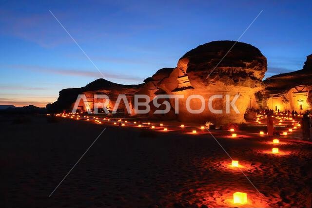 Hegra After Dark experience at the Jabal Al-Khuraymat site of Hegra - Nabataean tombs illuminated by lanterns in AlUla, Saudi Arabia