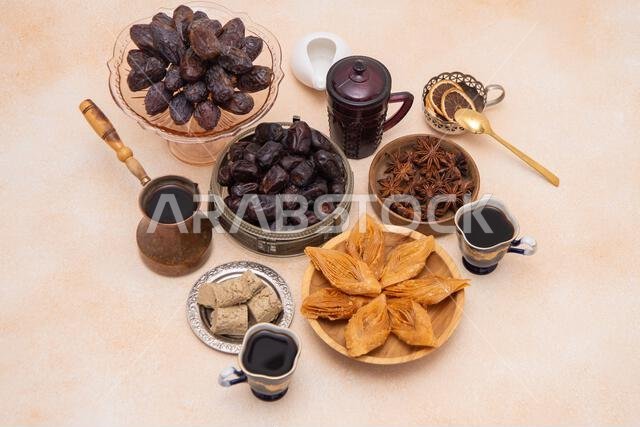 حلويات شرقية وأكواب قهوة على الطاولة خلال شهر رمضان. بقلاوة وتمر من الأعلى. خلفية من الحلويات حلويات شرقية وأكواب قهوة على الطاولة خلال شهر رمضان. بقلاوة وتمر من الأعلى. خلفية من الحلويات
