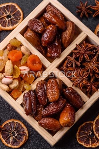 Dried dates on a ceramic plate for Ramadan or Iftar. Dried dates as a food background for your design