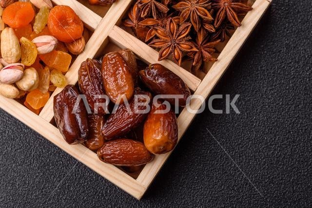 Dried dates on a ceramic plate for Ramadan or Iftar. Dried dates as a food background for your design