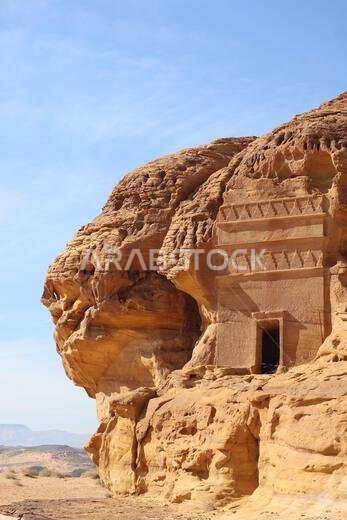 Ancient rock-cut tomb carved into sandstone cliff at Hegra (Madain Saleh), AlUla, Saudi Arabia.